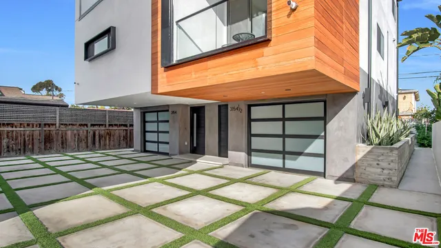 a view of a hallway with wooden floor and entryway