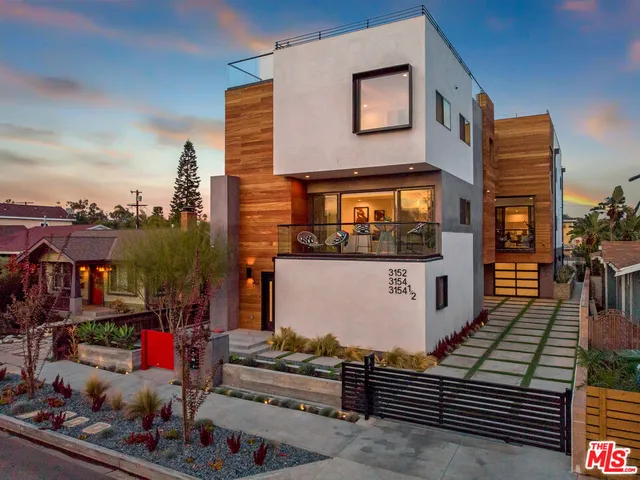 a front view of a house with many windows