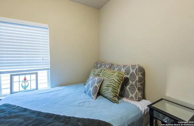 a bedroom with a bed and a window