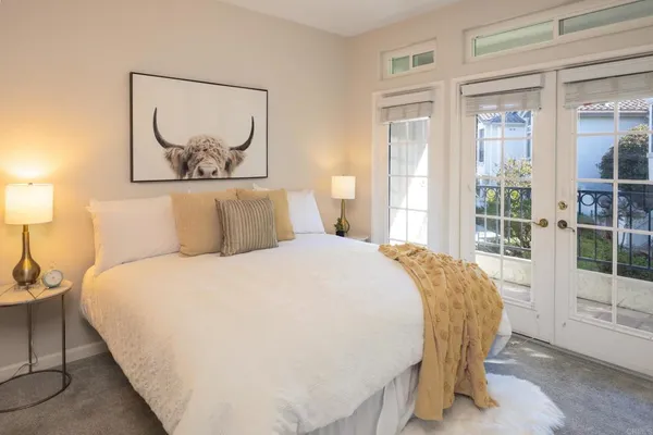 a bed sitting in a bedroom next to a window