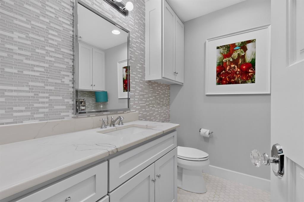 4548 Roland Avenue, Unit A Dallas, TX 75219 - Photo 20 of 31 Vanity with a rectangular undermount sink, a chrome faucet, and a quartz countertop