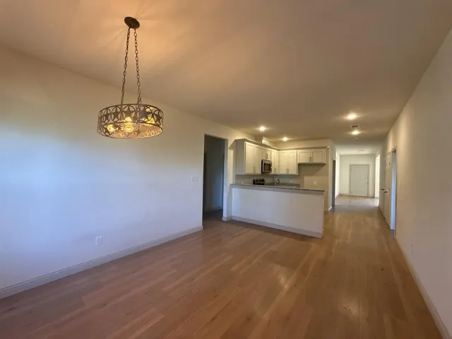 a view of a kitchen with a stove cabinets and a wooden floor