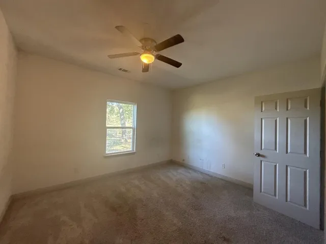 an empty room with windows and closet
