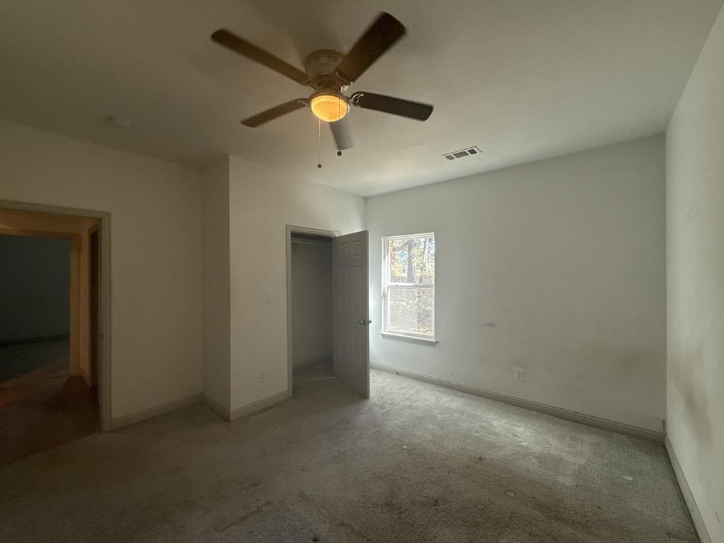 129 Towering Oaks Tool, TX 75143 - Photo 10 of 20 an empty room with a window and a fan