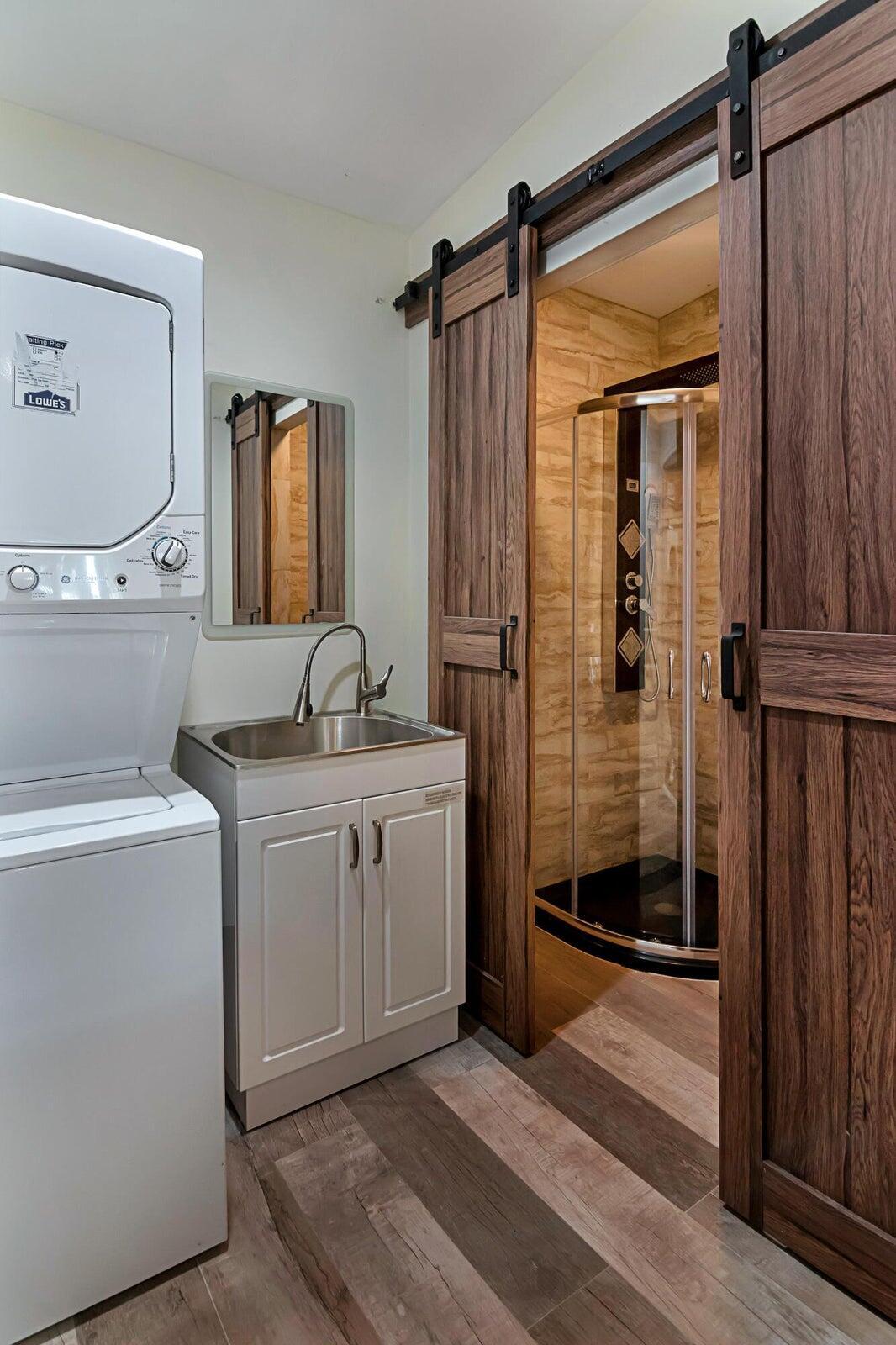 959 Southwest 18th Street, Unit W Boca Raton, FL 33486 - Photo 11 of 18 a bathroom with a double vanity sink mirror and shower