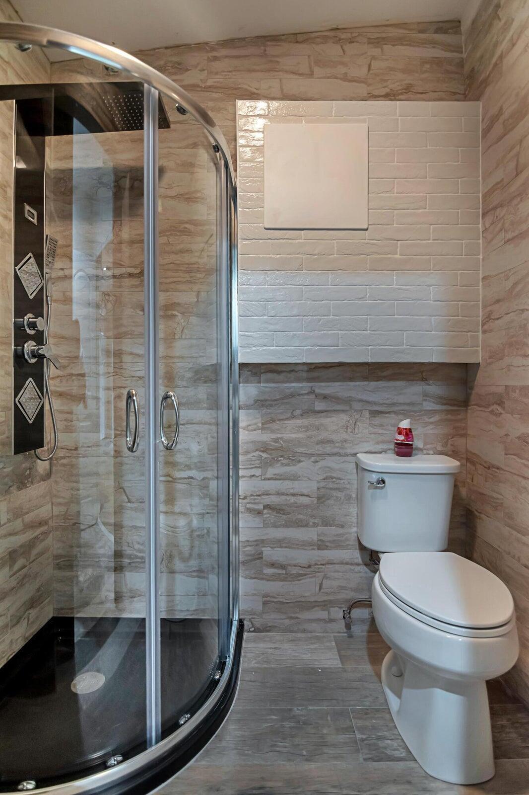 959 Southwest 18th Street, Unit W Boca Raton, FL 33486 - Photo 12 of 18 a bathroom with a toilet and a shower