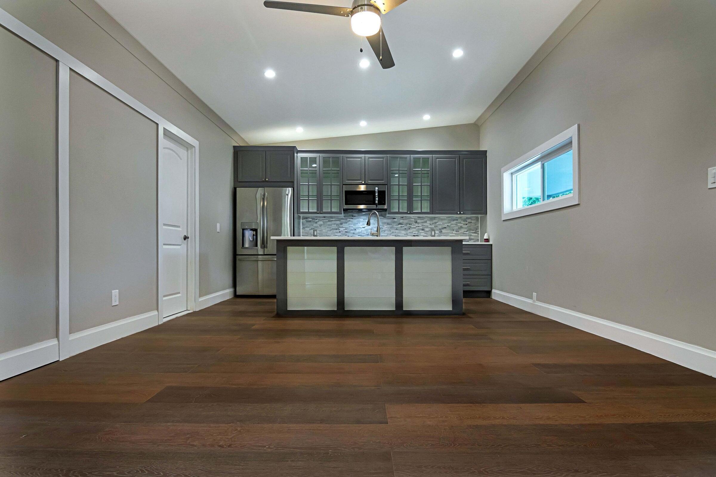 959 Southwest 18th Street, Unit W Boca Raton, FL 33486 - Photo 3 of 18 a view of kitchen with stainless steel appliances granite countertop cabinets and wooden floor