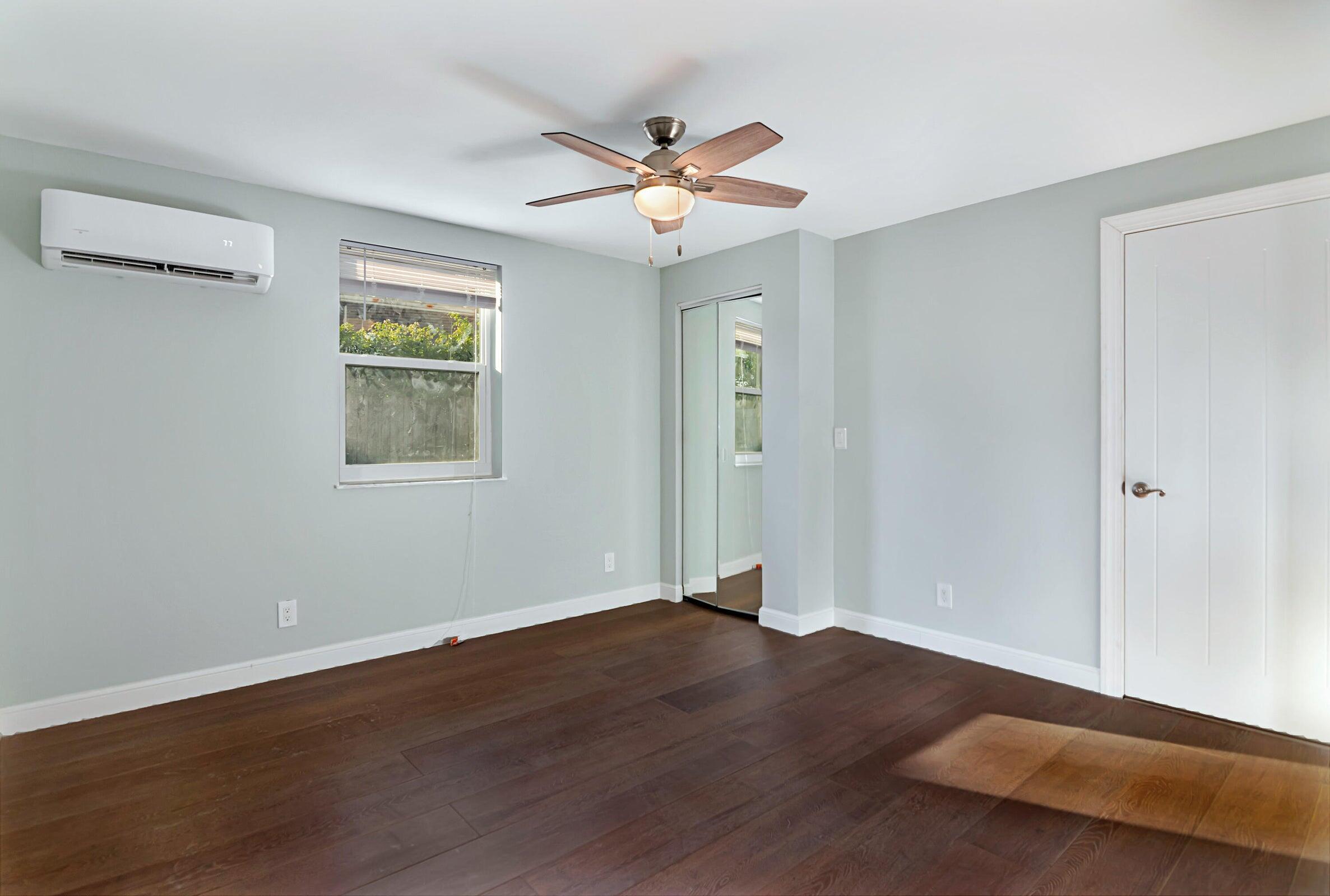 959 Southwest 18th Street, Unit W Boca Raton, FL 33486 - Photo 5 of 18 a view of a livingroom with wooden floor and a ceiling fan