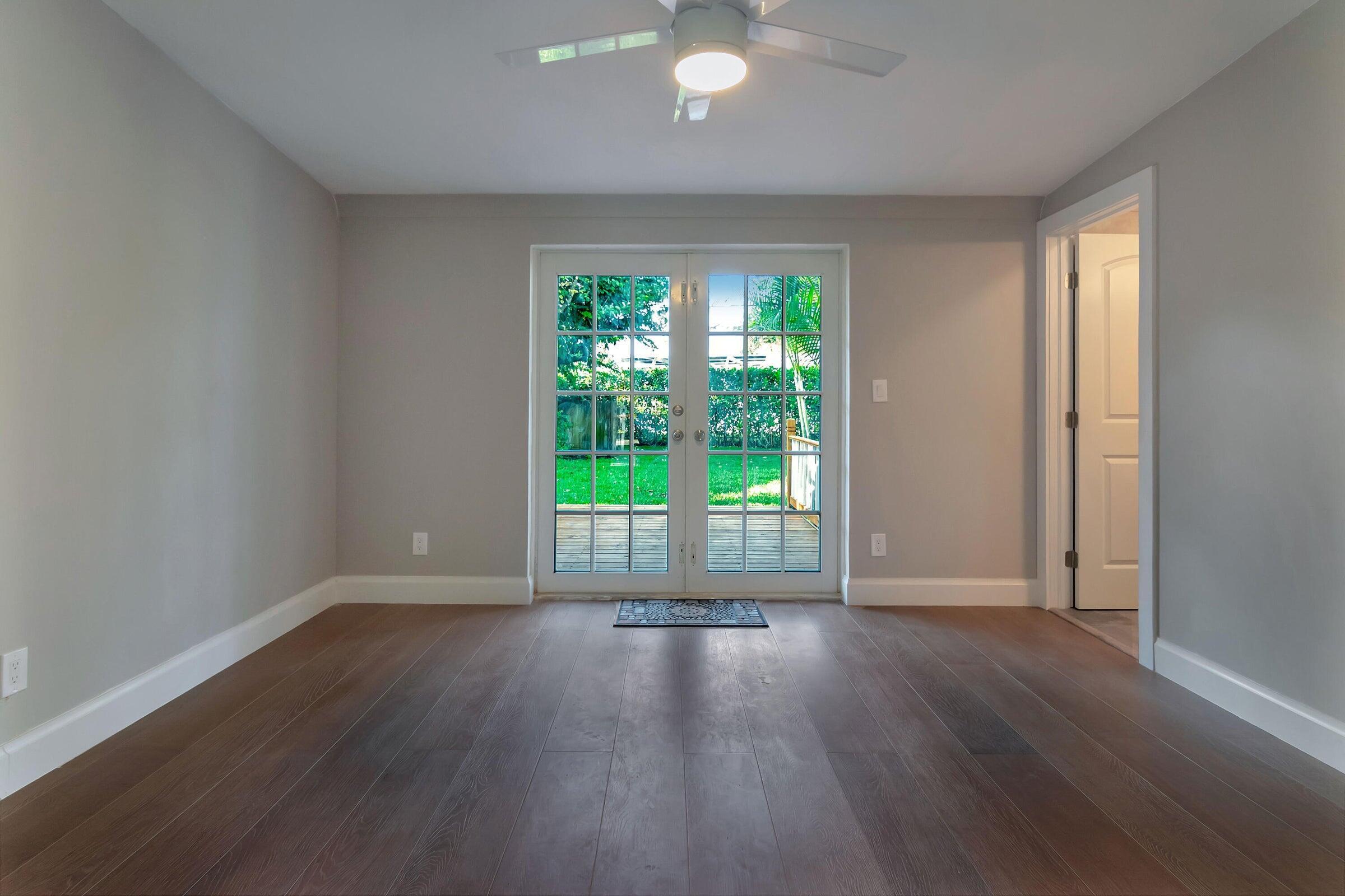 959 Southwest 18th Street, Unit W Boca Raton, FL 33486 - Photo 8 of 18 wooden floor in an empty room with a window