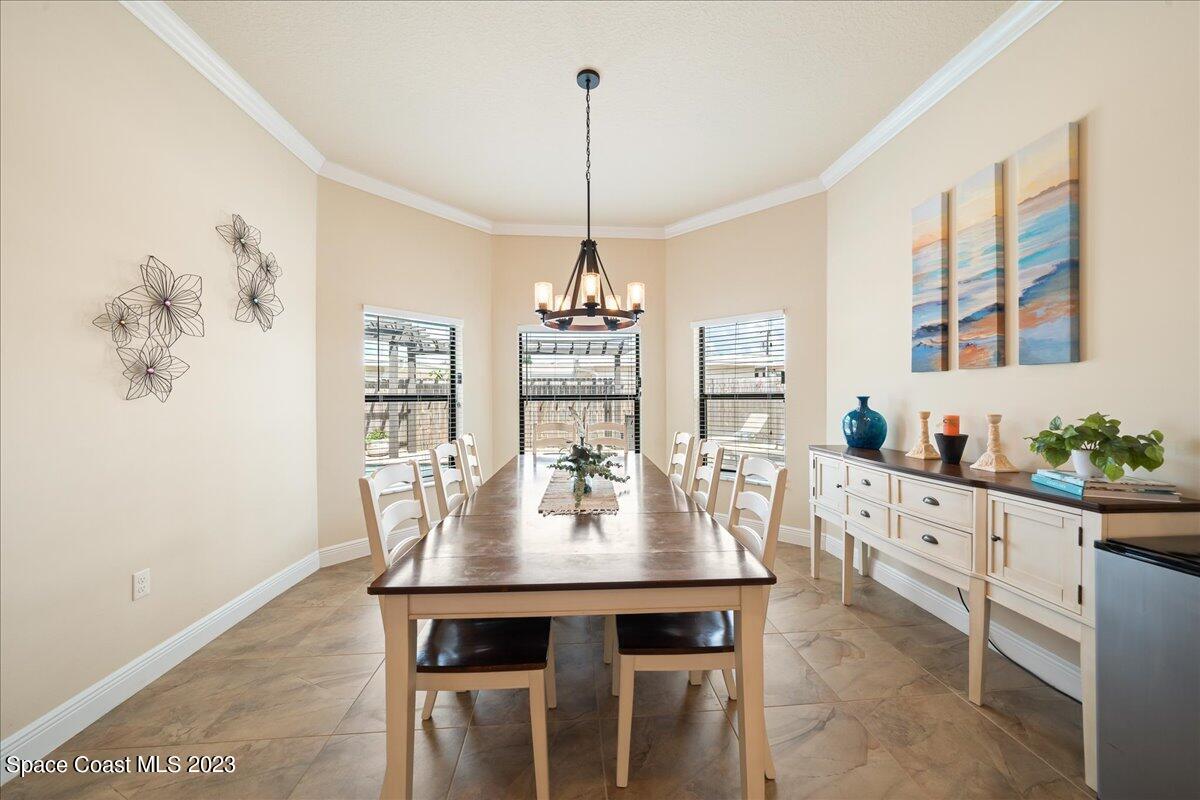 671 Palm Drive Satellite Beach, FL 32937 - Photo 16 of 69 a dining room with furniture a chandelier and window