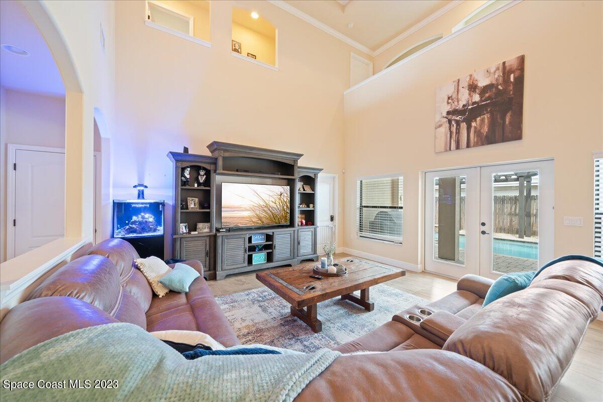 671 Palm Drive Satellite Beach, FL 32937 - Photo 17 of 69 a living room with furniture and a flat screen tv