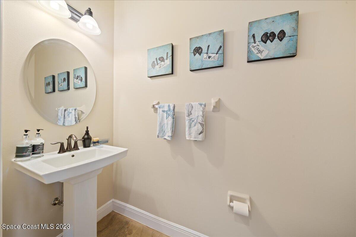 671 Palm Drive Satellite Beach, FL 32937 - Photo 19 of 69 a bathroom with a sink and a mirror