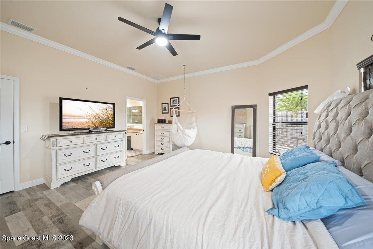 671 Palm Drive Satellite Beach, FL 32937 - Photo 21 of 69 a bedroom with a bed and a flat screen tv