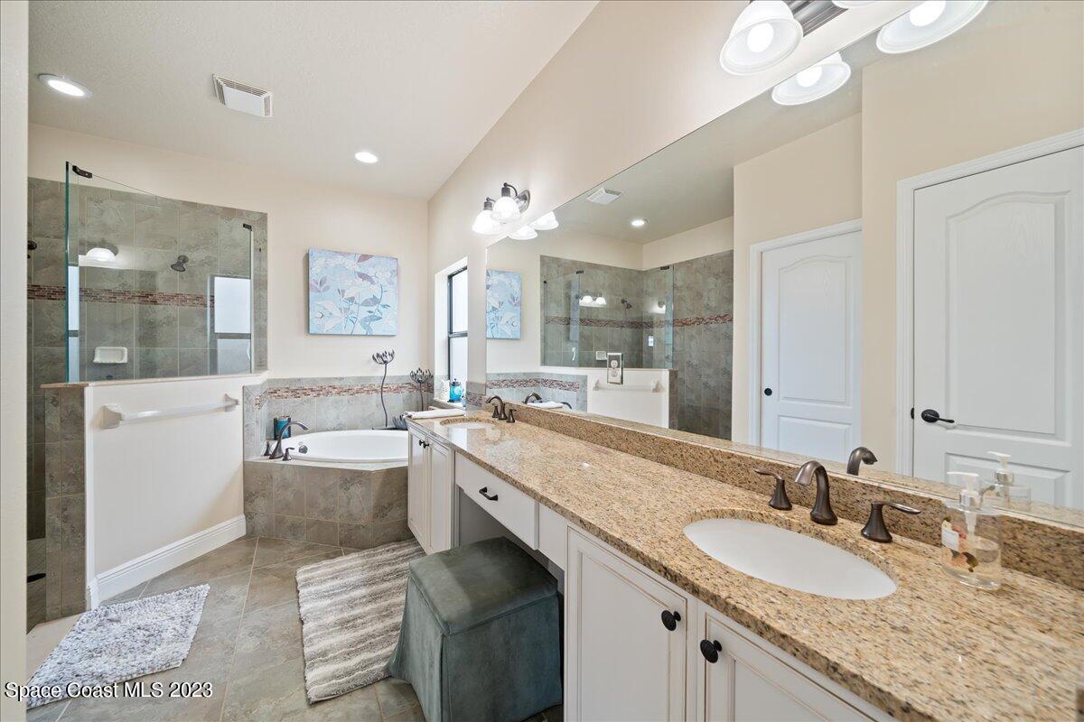 671 Palm Drive Satellite Beach, FL 32937 - Photo 22 of 69 a bathroom with a granite countertop sink and a mirror