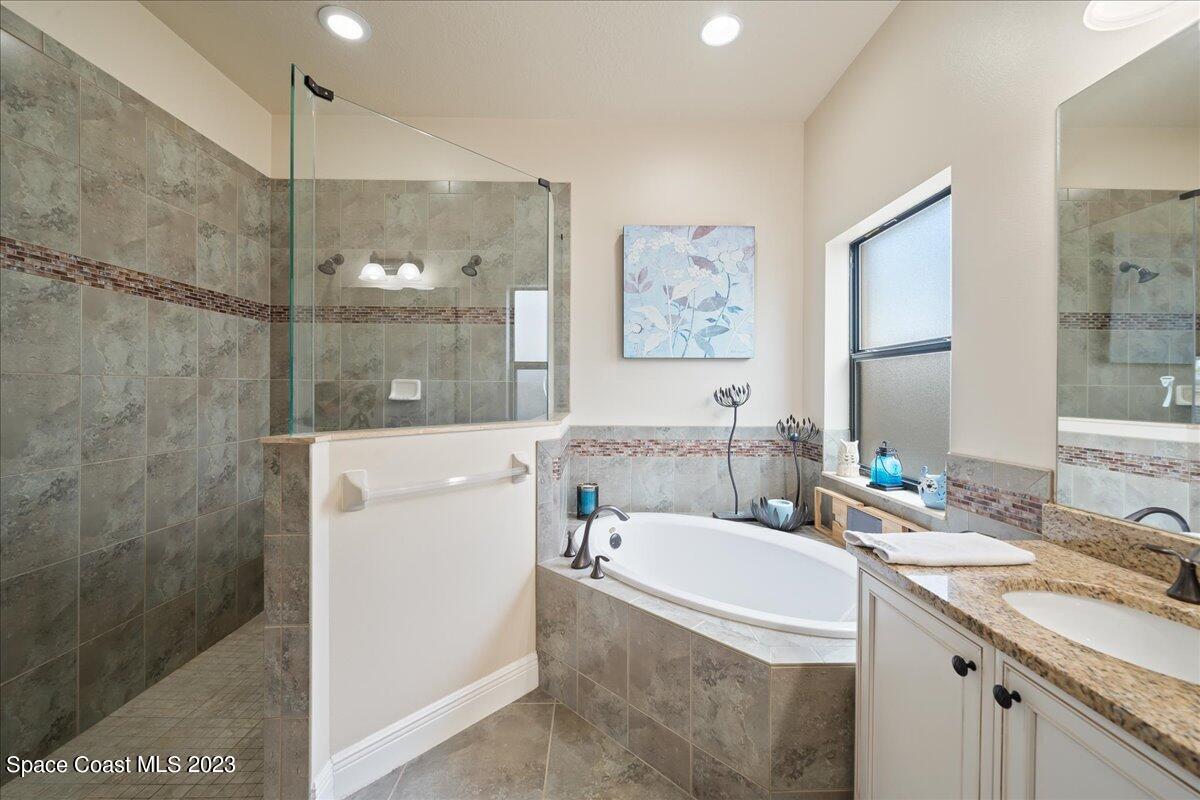 671 Palm Drive Satellite Beach, FL 32937 - Photo 23 of 69 a bathroom with a granite countertop sink mirror and a bath tub