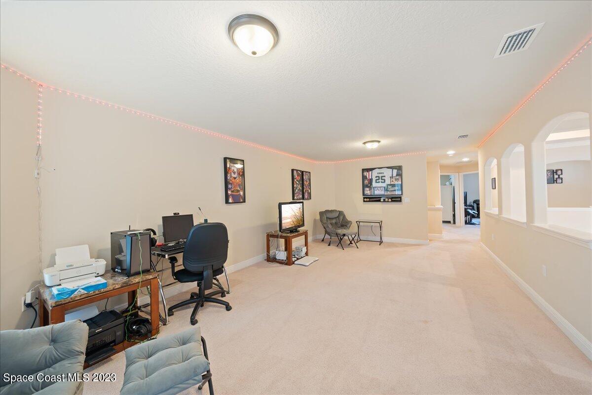 671 Palm Drive Satellite Beach, FL 32937 - Photo 24 of 69 a living room with furniture and a table