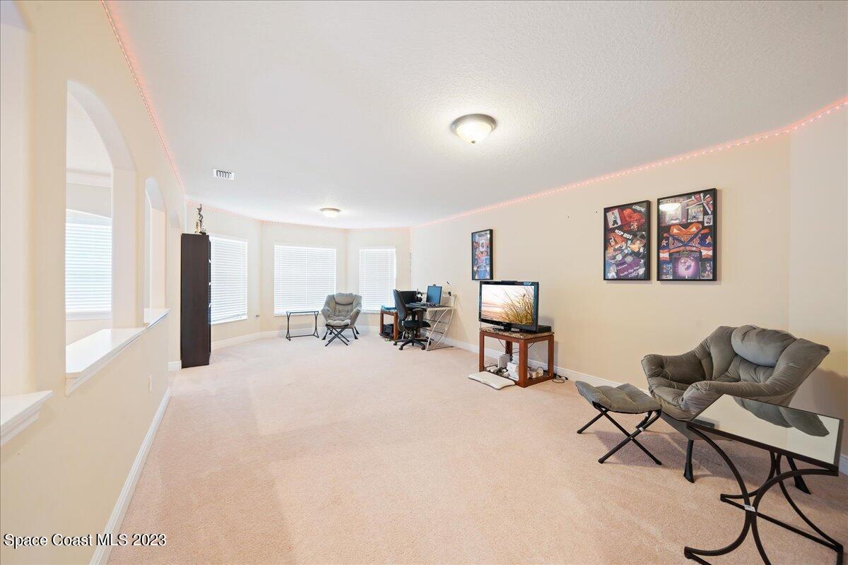 671 Palm Drive Satellite Beach, FL 32937 - Photo 25 of 69 a view of a livingroom with workspace and a couch