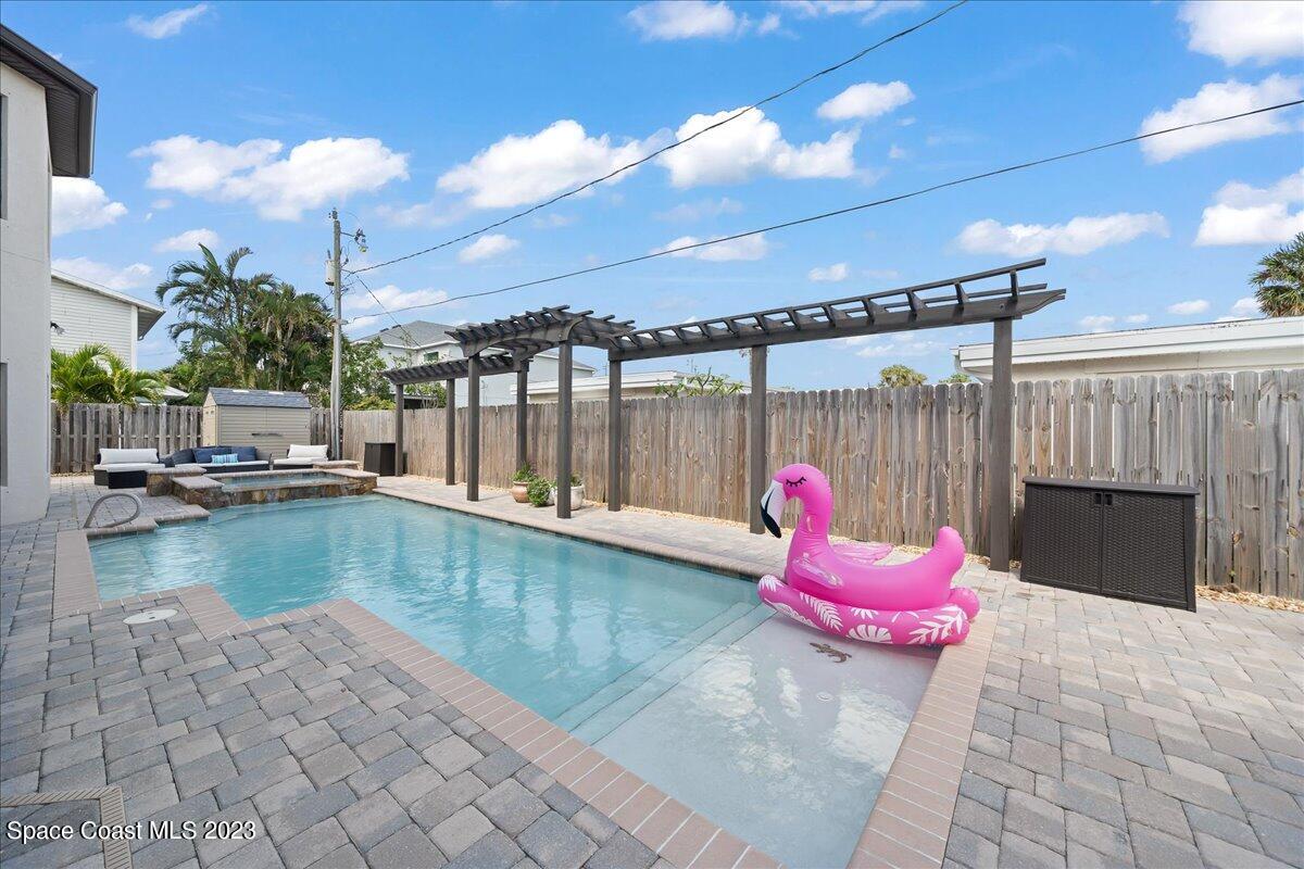 671 Palm Drive Satellite Beach, FL 32937 - Photo 3 of 69 a swimming pool with yard outdoor seating and fire pit