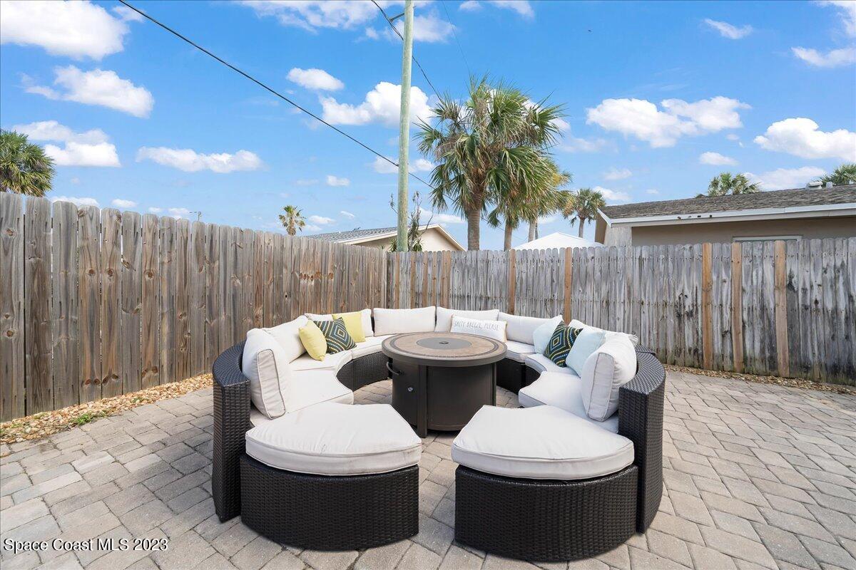 671 Palm Drive Satellite Beach, FL 32937 - Photo 37 of 69 a view of a patio with table and chairs with wooden fence