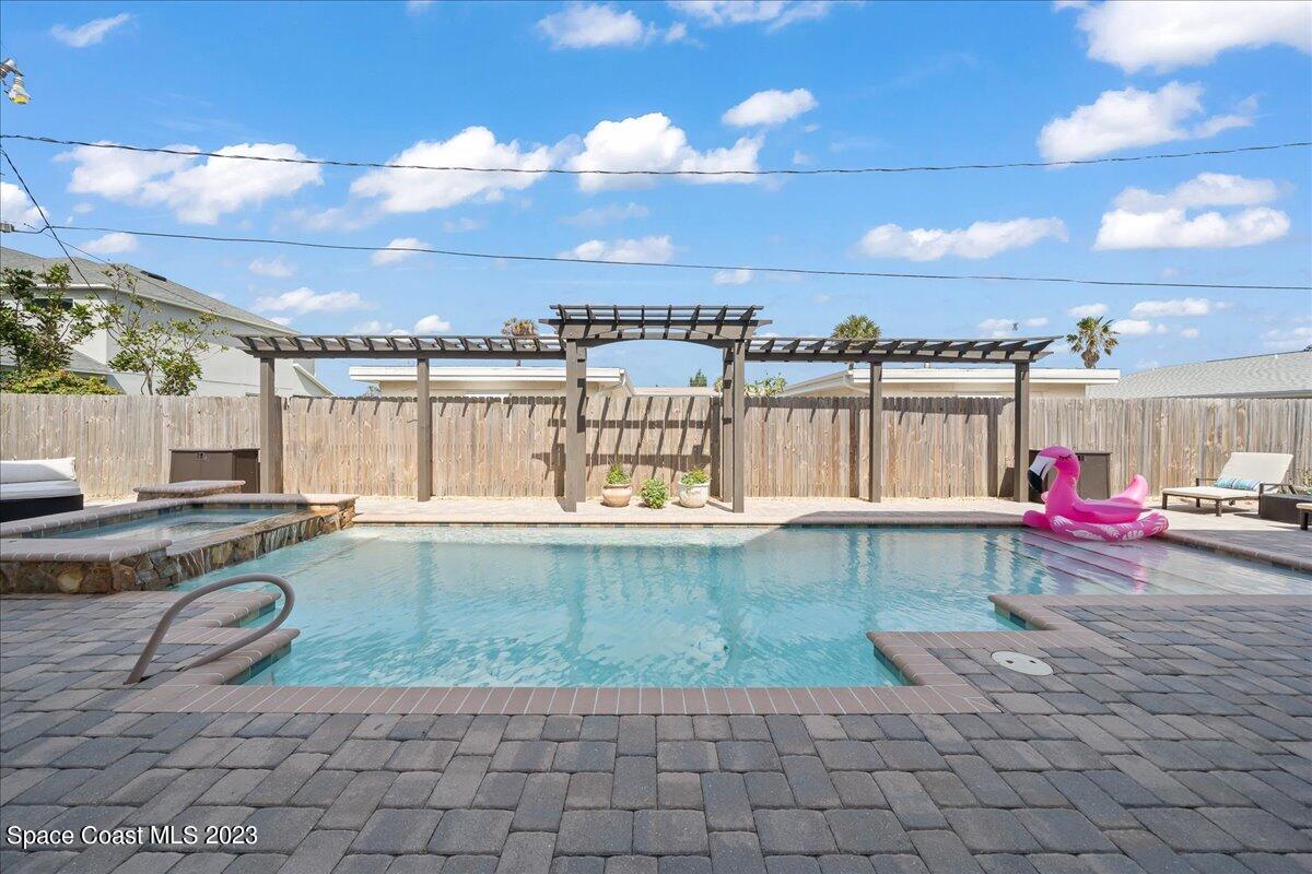 671 Palm Drive Satellite Beach, FL 32937 - Photo 40 of 69 a view of a swimming pool with a patio and a yard