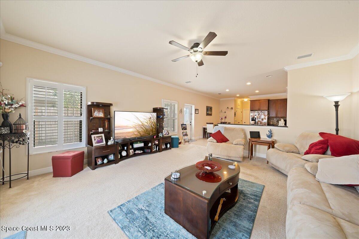 671 Palm Drive Satellite Beach, FL 32937 - Photo 45 of 69 a living room with furniture and a flat screen tv