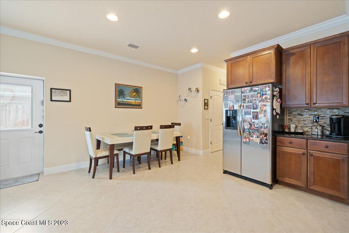 671 Palm Drive Satellite Beach, FL 32937 - Photo 49 of 69 a open kitchen with stainless steel appliances granite countertop a refrigerator and dining table