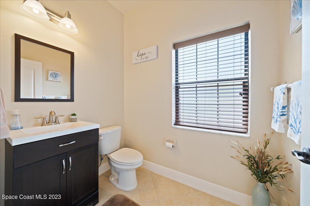 671 Palm Drive Satellite Beach, FL 32937 - Photo 50 of 69 a bathroom with a toilet sink and mirror