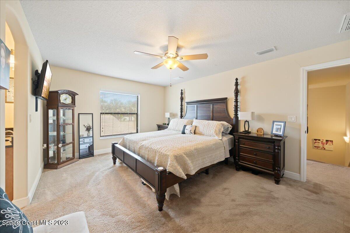 671 Palm Drive Satellite Beach, FL 32937 - Photo 51 of 69 a bed room with a bed and a chandelier
