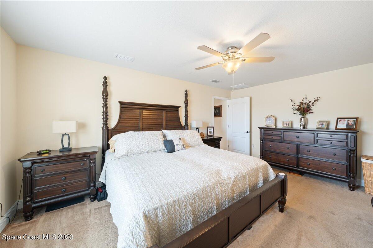 671 Palm Drive Satellite Beach, FL 32937 - Photo 52 of 69 a bedroom with a bed and a chandelier
