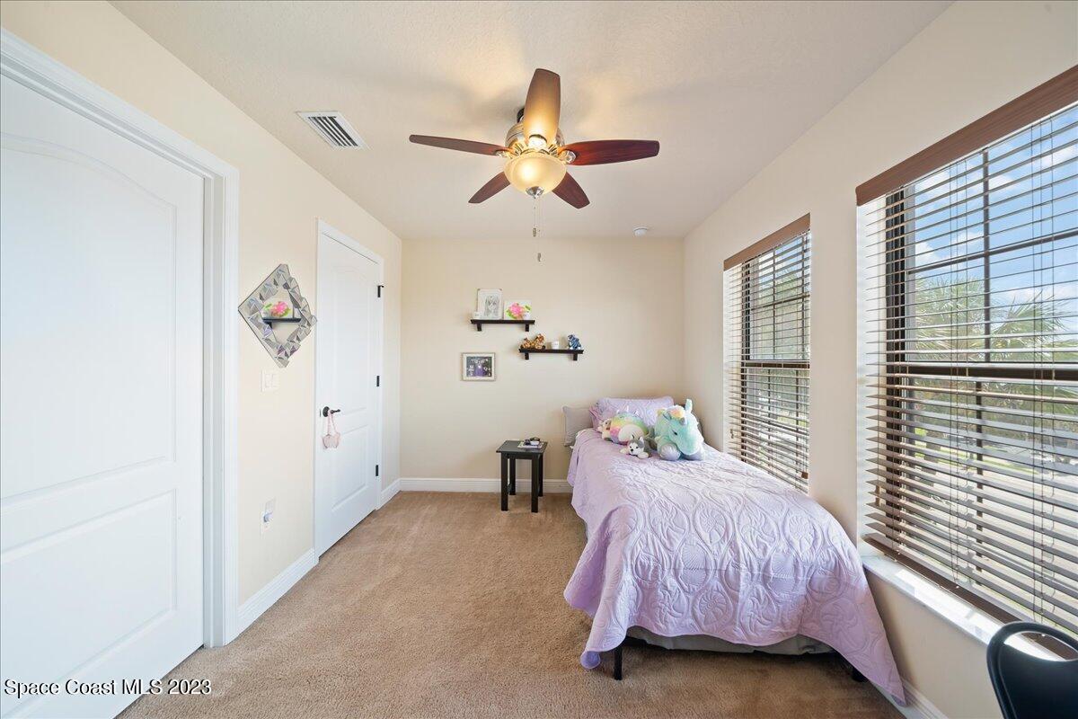 671 Palm Drive Satellite Beach, FL 32937 - Photo 58 of 69 a bedroom with a bed and a chandelier