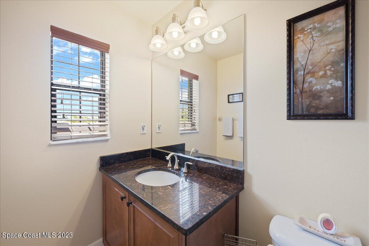 671 Palm Drive Satellite Beach, FL 32937 - Photo 59 of 69 a bathroom with a granite countertop sink and a mirror