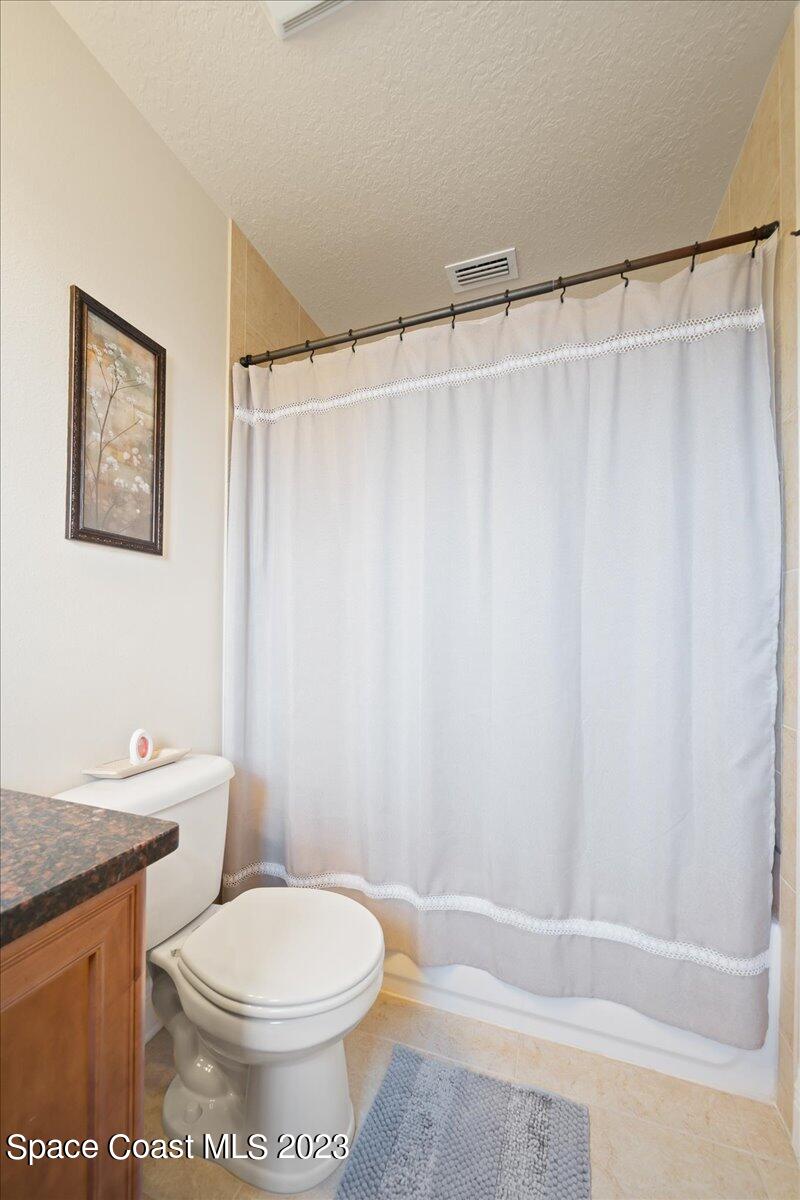 671 Palm Drive Satellite Beach, FL 32937 - Photo 60 of 69 a bathroom with a toilet and a shower curtain