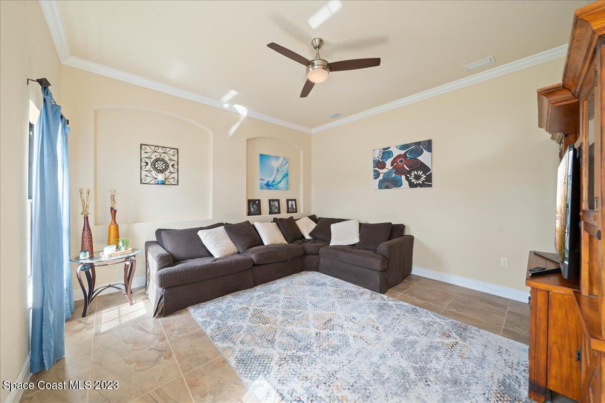 671 Palm Drive Satellite Beach, FL 32937 - Photo 9 of 69 a living room with furniture and a flat screen tv