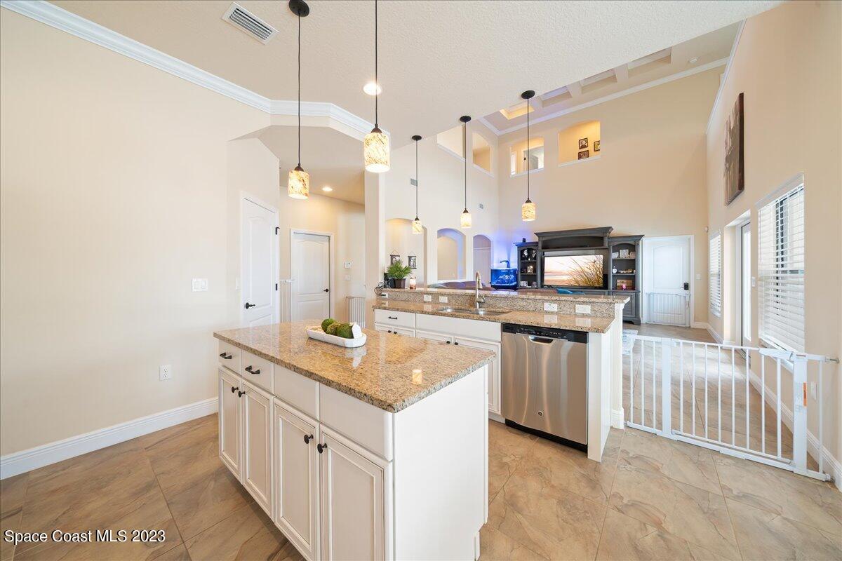 671 Palm Drive Satellite Beach, FL 32937 - Photo 10 of 69 a kitchen with white cabinets and sink