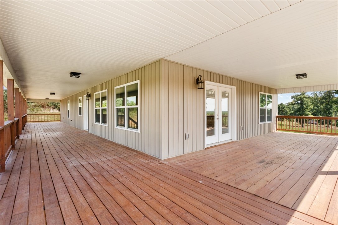 9294 Sugar Road North Harrison, AR 72601 - Photo 11 of 39 front porch on left, side porch on right for outdoor grilling, patio doors to dining & kitchen