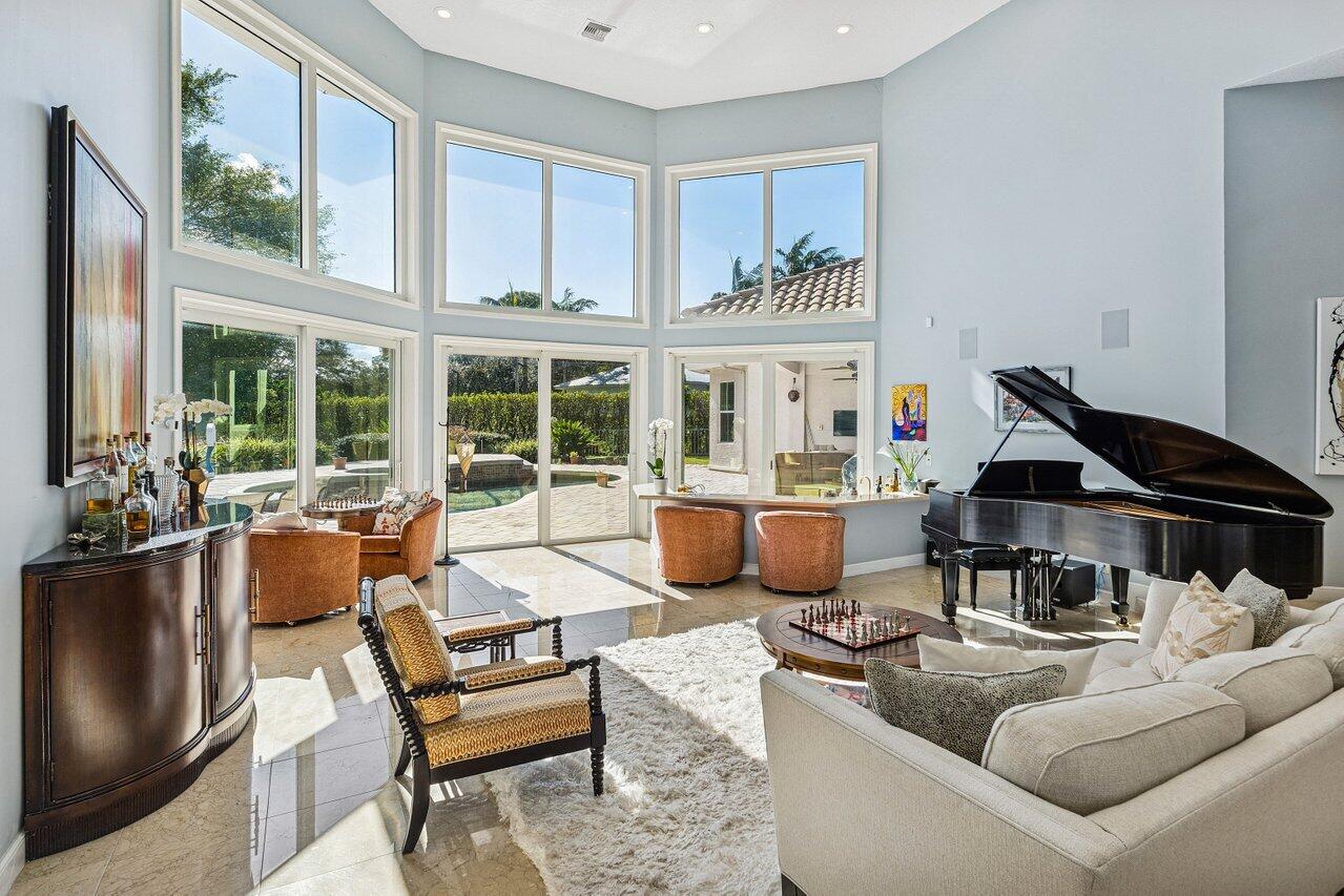 2450 Northwest 41st Street Boca Raton, FL 33431 - Photo 12 of 62 a living room with furniture and floor to ceiling windows