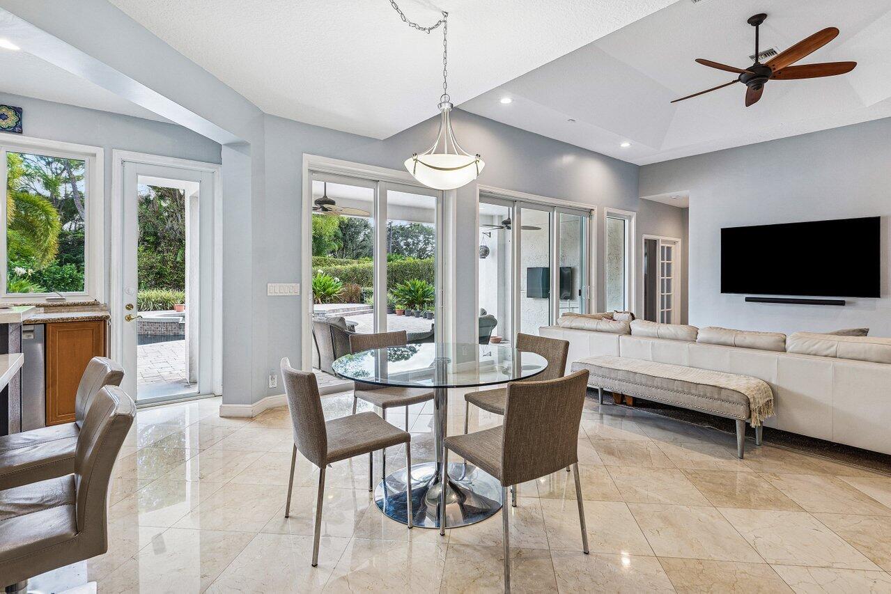 2450 Northwest 41st Street Boca Raton, FL 33431 - Photo 16 of 62 a living room with furniture a flat screen tv and a large window