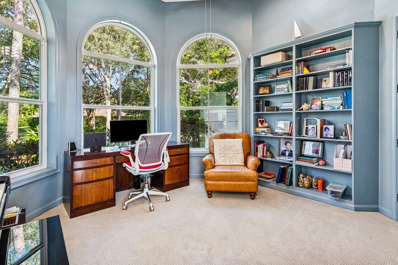 2450 Northwest 41st Street Boca Raton, FL 33431 - Photo 18 of 62 a living room with furniture a bookshelf and a large window
