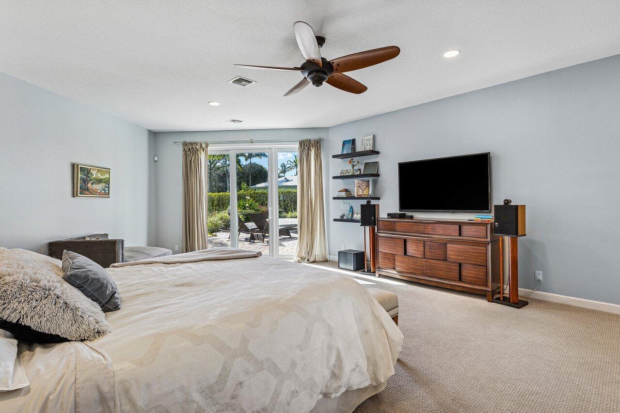 2450 Northwest 41st Street Boca Raton, FL 33431 - Photo 20 of 62 a bedroom with a bed and a flat screen tv