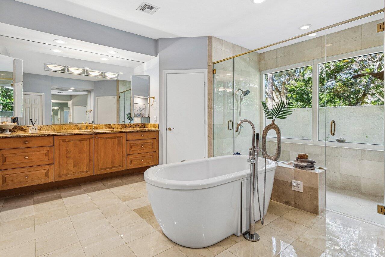2450 Northwest 41st Street Boca Raton, FL 33431 - Photo 21 of 62 a bathroom with a sink a toilet and bathtub