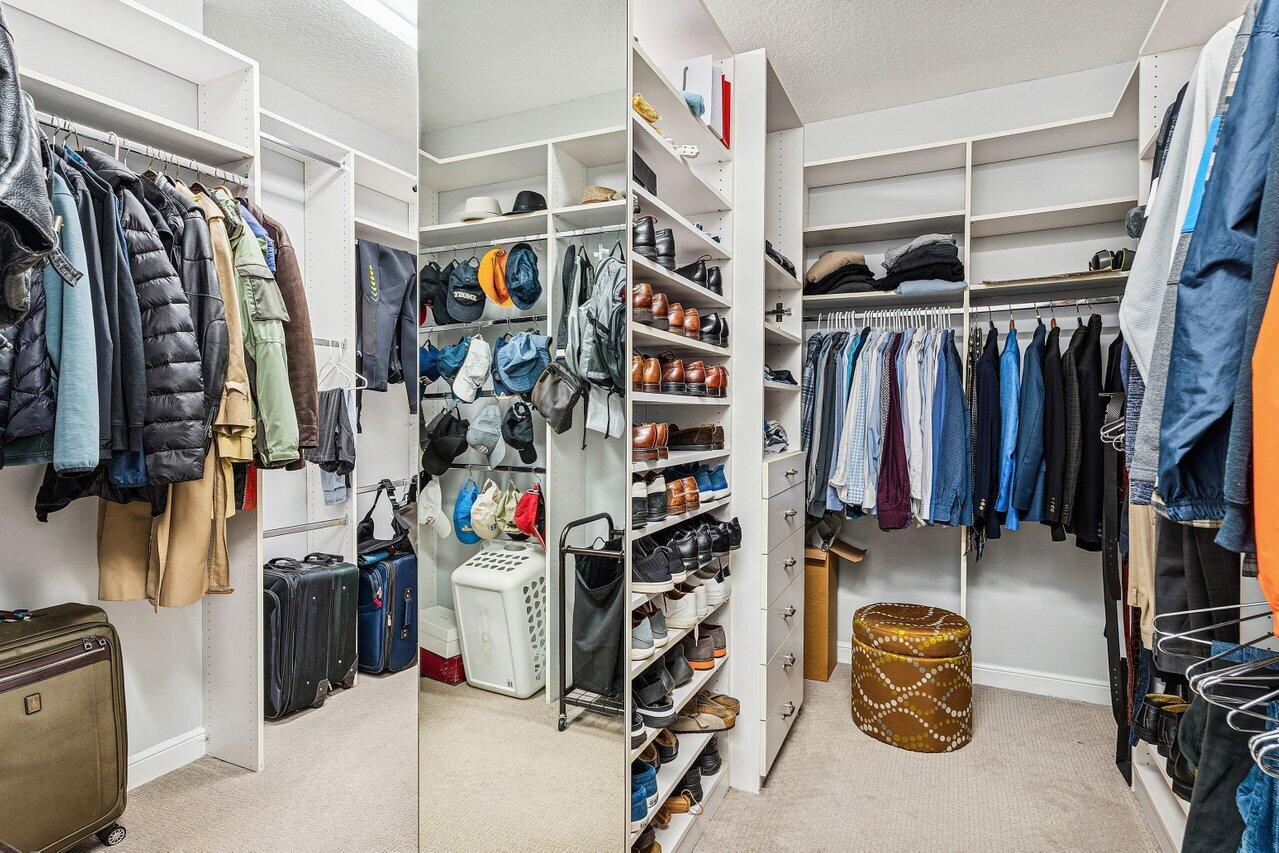 2450 Northwest 41st Street Boca Raton, FL 33431 - Photo 22 of 62 a view of walk in closet with clothes and shoes