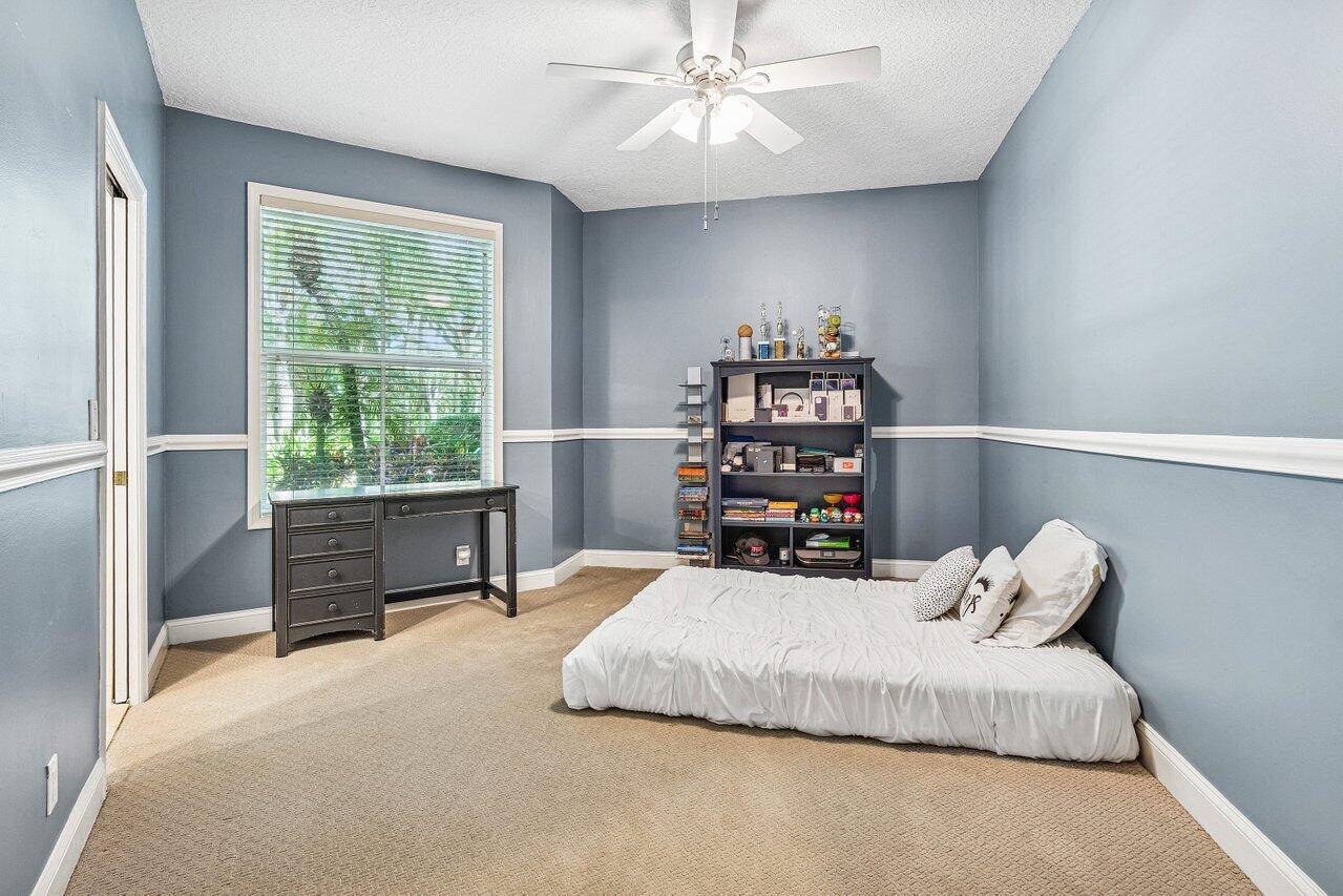 2450 Northwest 41st Street Boca Raton, FL 33431 - Photo 23 of 62 a bedroom with a bed and a large window
