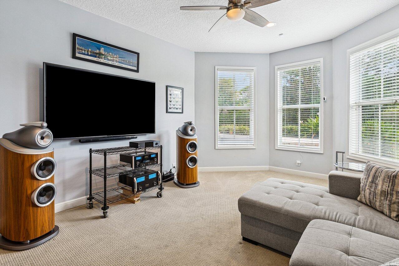 2450 Northwest 41st Street Boca Raton, FL 33431 - Photo 29 of 62 a living room with furniture and a flat screen tv