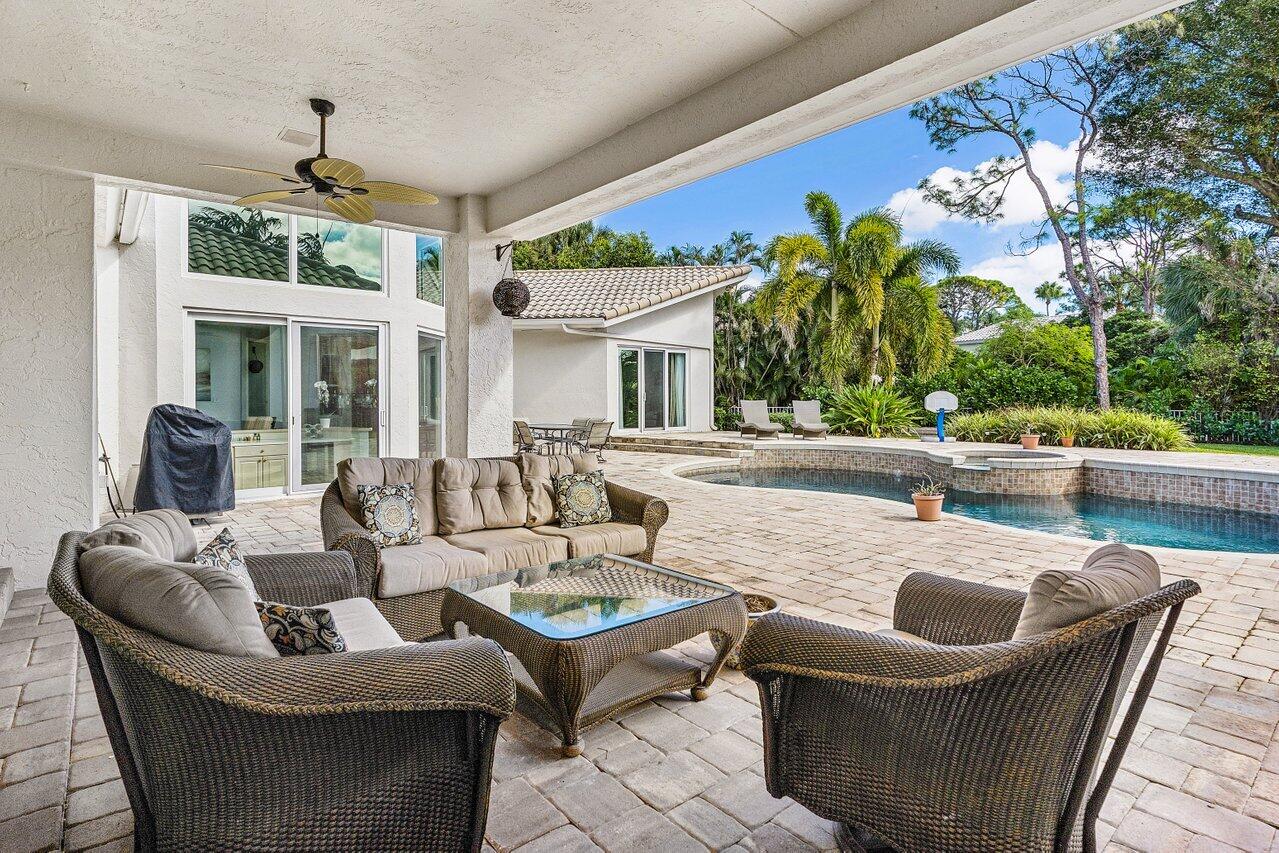 2450 Northwest 41st Street Boca Raton, FL 33431 - Photo 32 of 62 a outdoor space with patio the couches and a dining table with garden view
