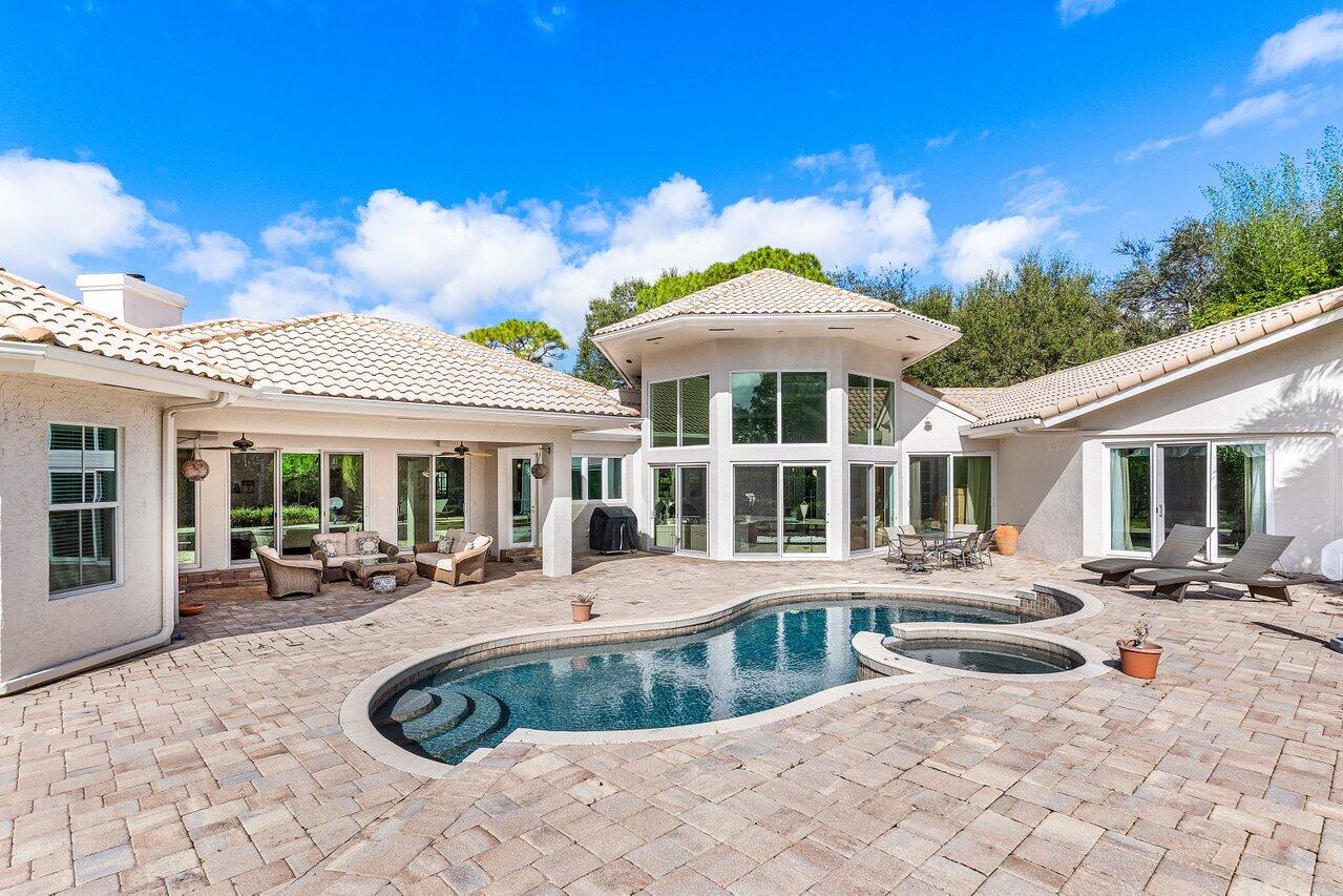 2450 Northwest 41st Street Boca Raton, FL 33431 - Photo 36 of 62 a view of a white house with swimming pool table and chairs