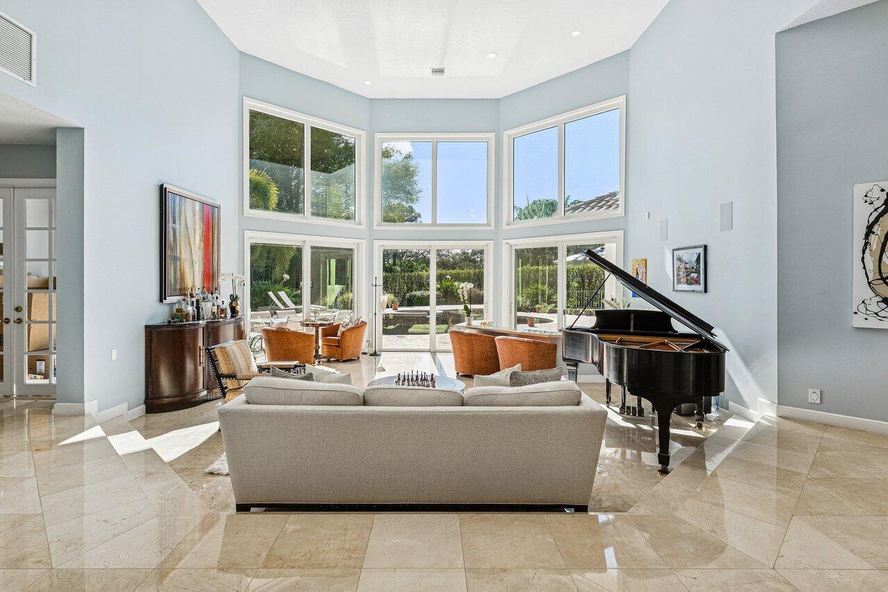2450 Northwest 41st Street Boca Raton, FL 33431 - Photo 10 of 62 a living room with furniture a large window and potted plants