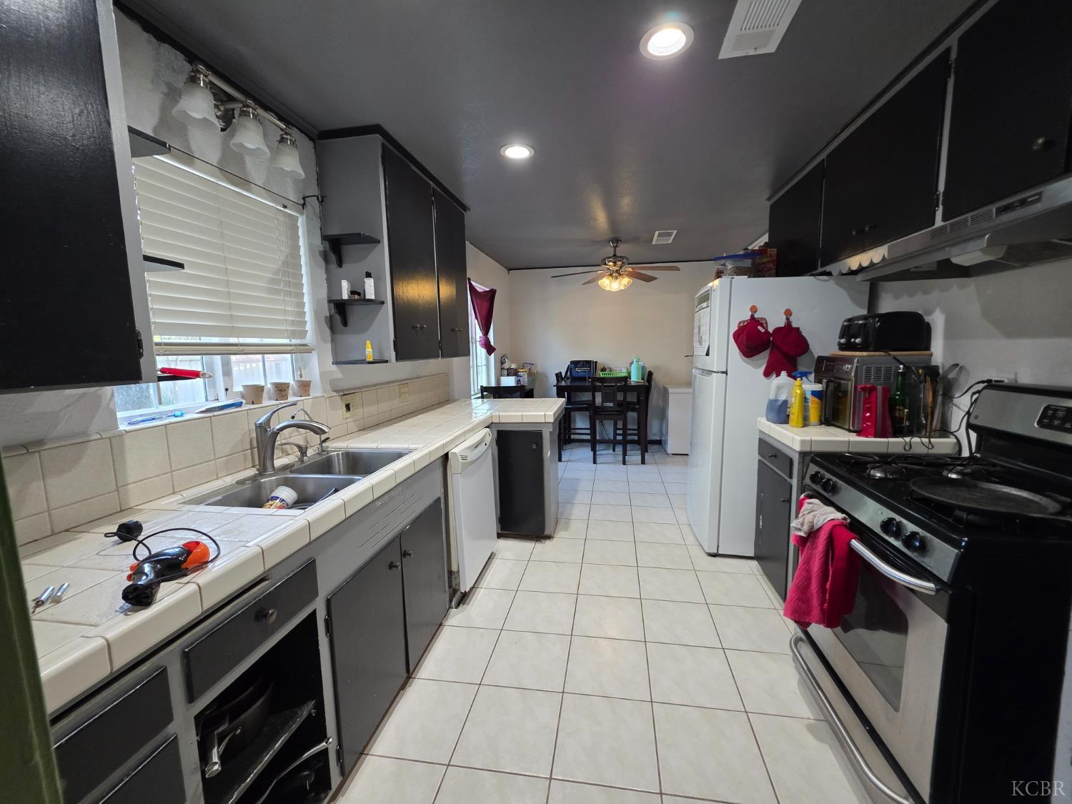 275 Ida Way Hanford, CA 93230 - Photo 5 of 21 a kitchen with a sink stove and cabinets