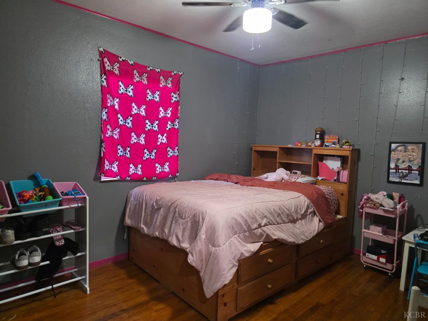 275 Ida Way Hanford, CA 93230 - Photo 10 of 21 a bedroom with a bed and a chandelier