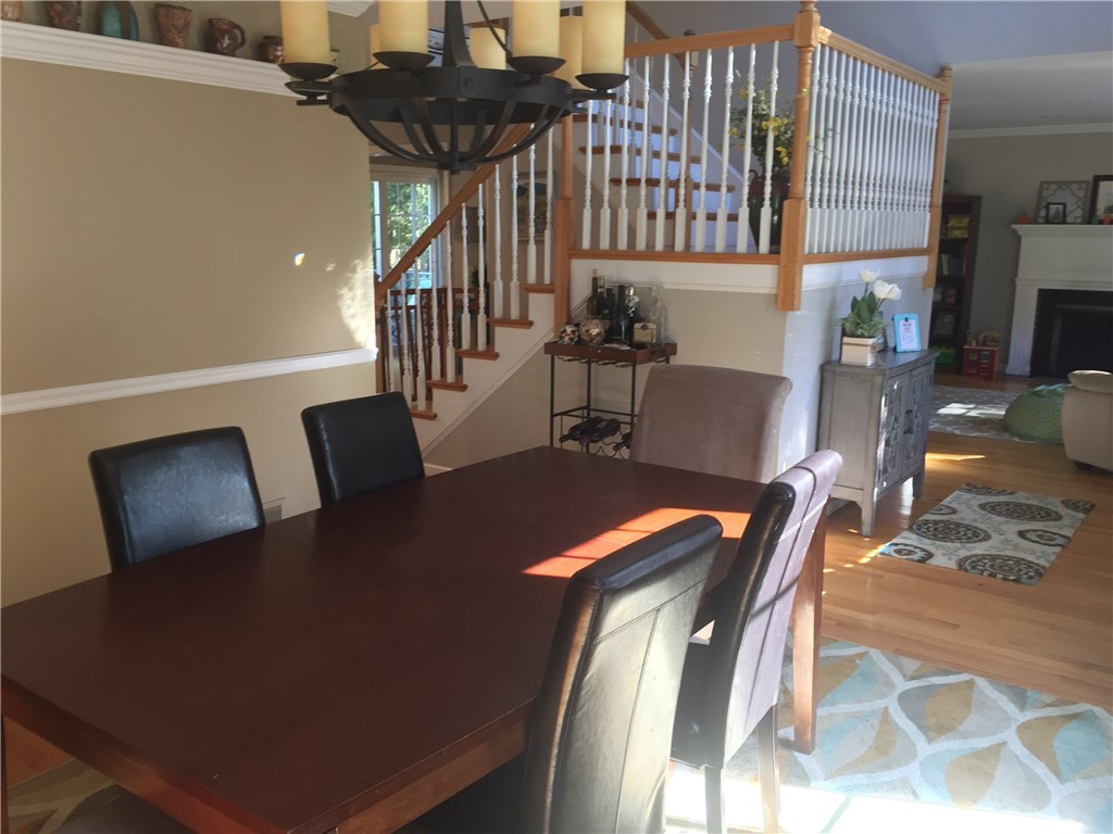 6 Princess Pine Road Lincoln, RI 02865 - Photo 15 of 40 This house has a fabulous flow. Each room leads to the next to make a complete circle. This perspective shows the view of the living room from the dining room as well as the open staircase. This layout is perfect for entertaining.