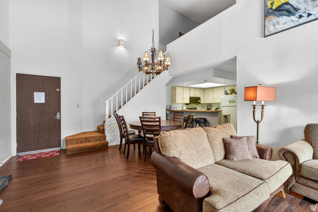 407 South Vasels Road, Unit 24 Brian Head, UT 84719 - Photo 8 of 63 Living room with suspended lighting, dark wood-style floors, and a high ceiling
